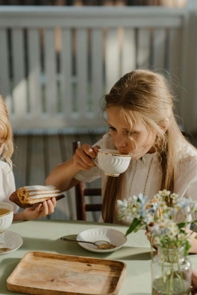 Mothers day brunch ideas hosted outdoors with throws on chairs and potted plants on the table