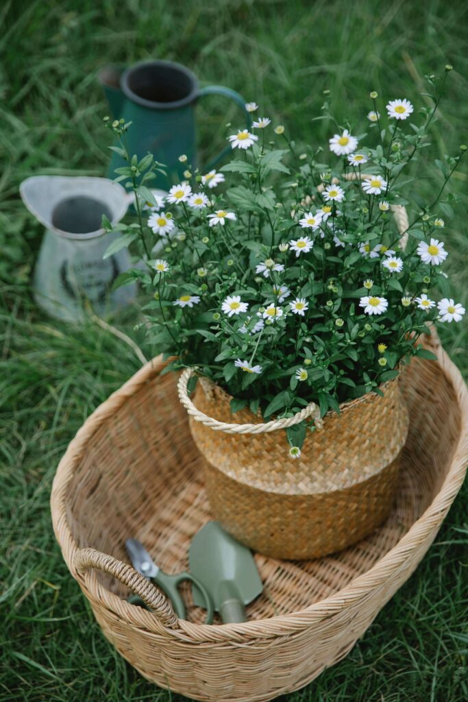 A vintage-style spring basket filled with wildflowers resting on a rustic porch step